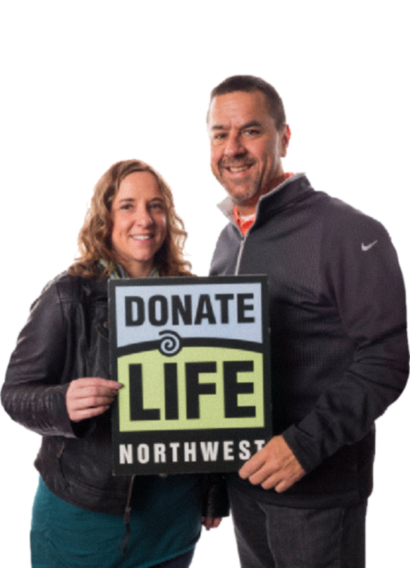 heterosexual couple holding a big donate life northwest logo