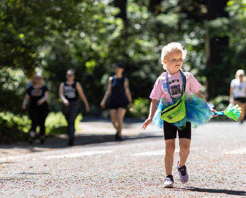 a child walking outside during a charity event