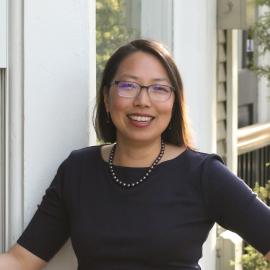 female staff member posing in front of building